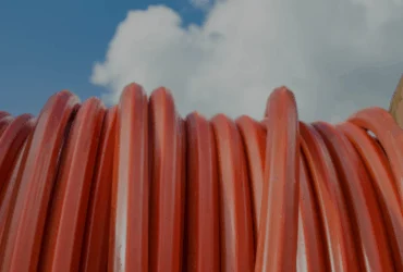Close up of fiber conduit with cloudy sky in background